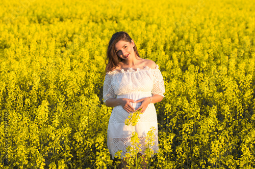Pregnant girl on the rapeseed field. cute young woman waiting a baby © SYARGEENKA