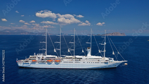 Aerial drone photo of classic cruise liner docked in deep blue Aegean sea
