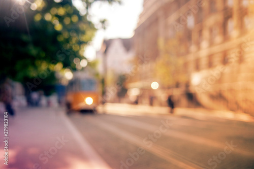 Background, blur, out of focus, bokeh. Soft sunlight, tram rides on the streets of the city.