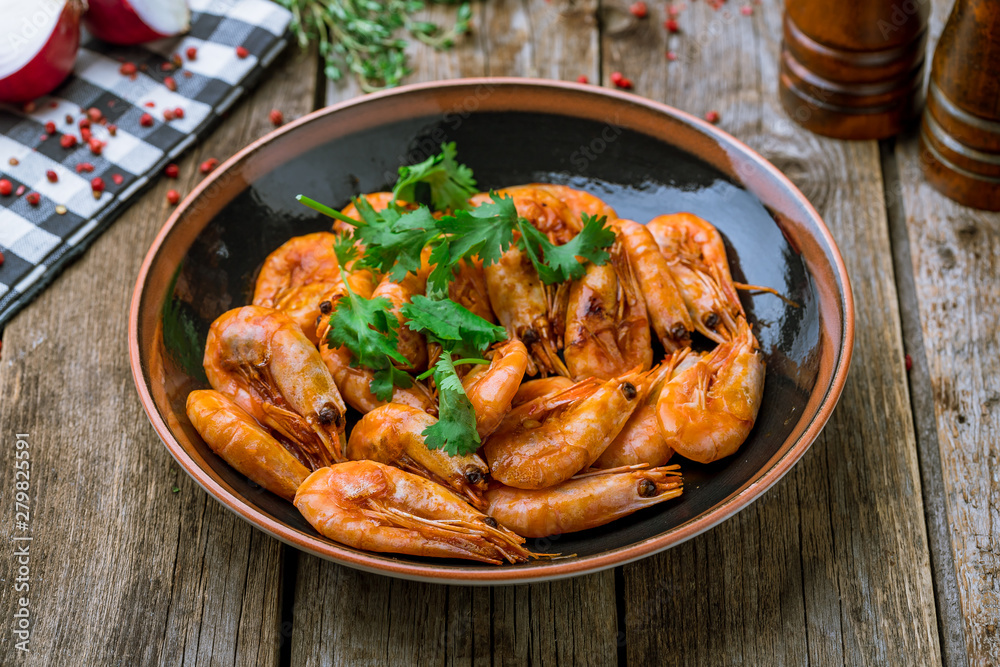 Tiger prawns on the grill on wooden background Tiger prawns on the grill on wooden background