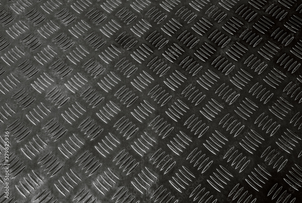 Corrugated dark and black pattern of non-slip ribbed metal or steel diamond plate rugged industrial floor textured background Corrugated dark and black pattern of non-slip ribbed metal or steel diamond plate rugged industrial floor textured background