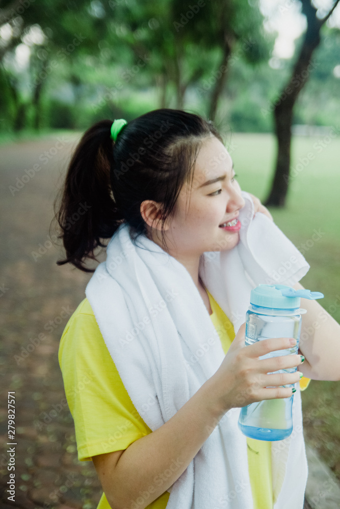Pretty young asian girl taking a break in the park in the morning. Fresh and healthy lifestyle for teenager. Pretty young asian girl taking a break in the park in the morning. Fresh and healthy lifestyle for teenager.