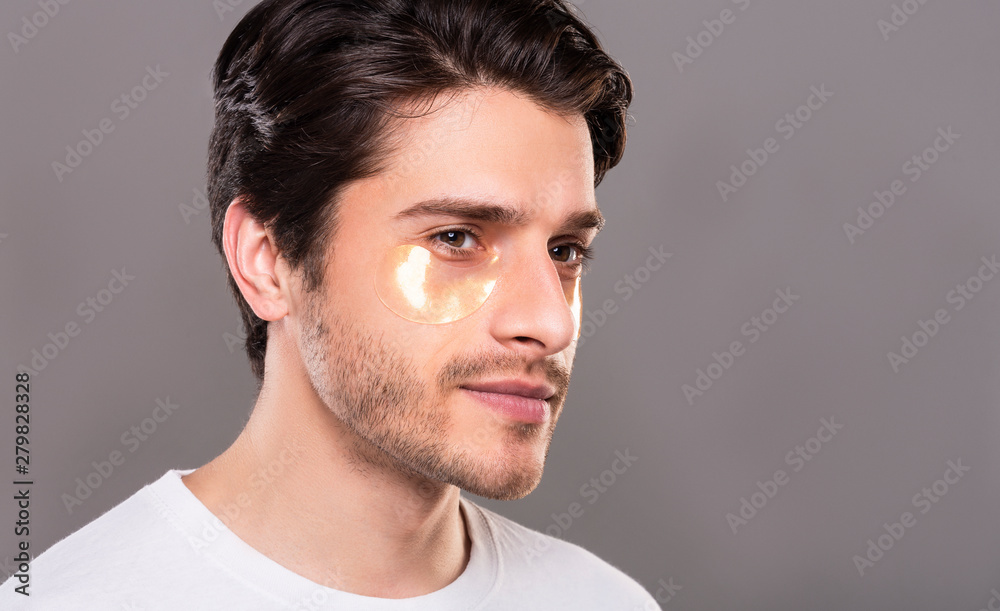 Young man with golden patches under eyes from wrinkles Young man with golden patches under eyes from wrinkles