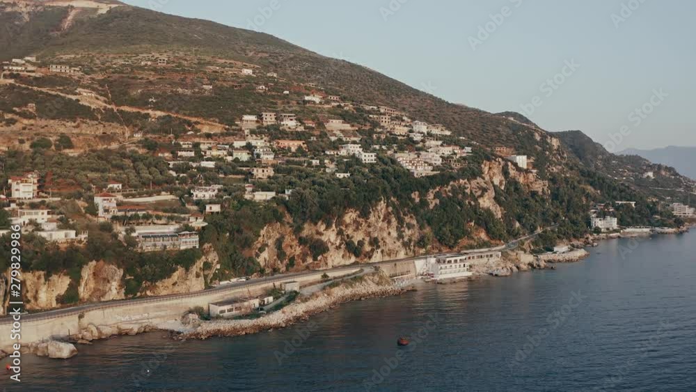 Ascending aerial shot of a coastline hotel revealing a bay 4k
