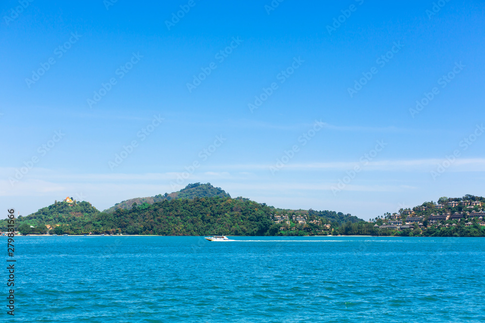 View of a green island in the blue ocean