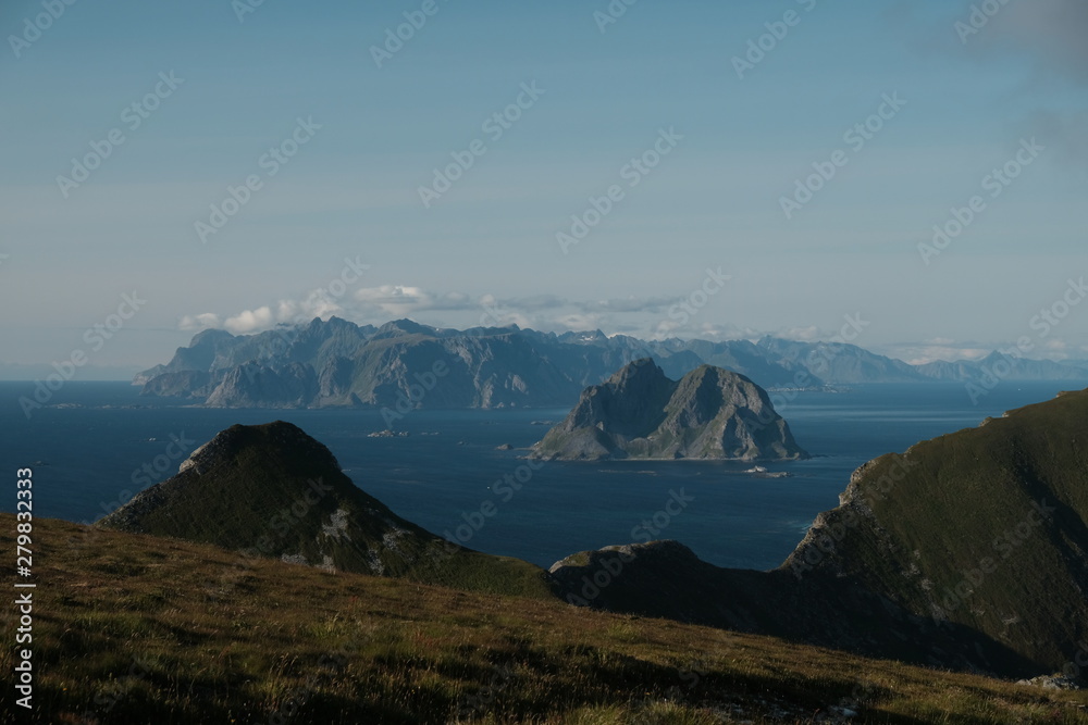 islands with a mountains and clear blue sky. a view from vaeroy island. Lofoten Islands