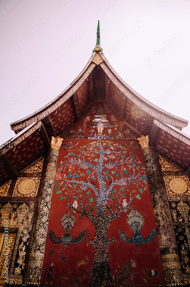 Golden Buddism Mural art and mosaic wall at Wat Xieng thong, Luang Prabang - Laos