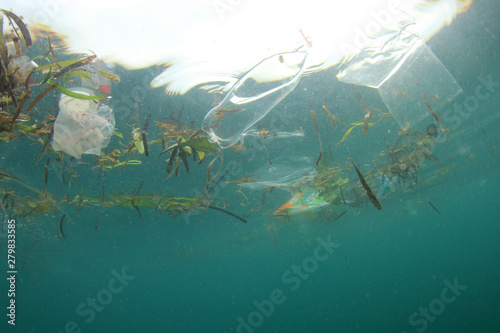 Plastic straws, bags and bottles pollution in ocean. 
