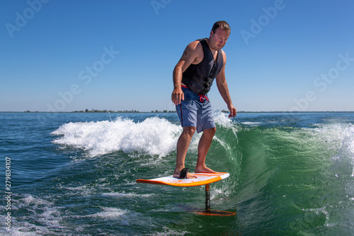 A wake surfer riding a foil board. photo