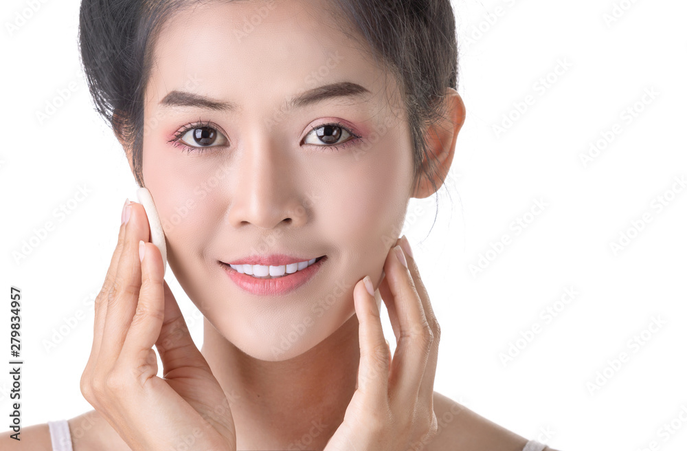 Beautiful Young Asian Woman using Powder, Sponge and Cosmetic on own face. Cosmetologist, Skin care or Beauty concept