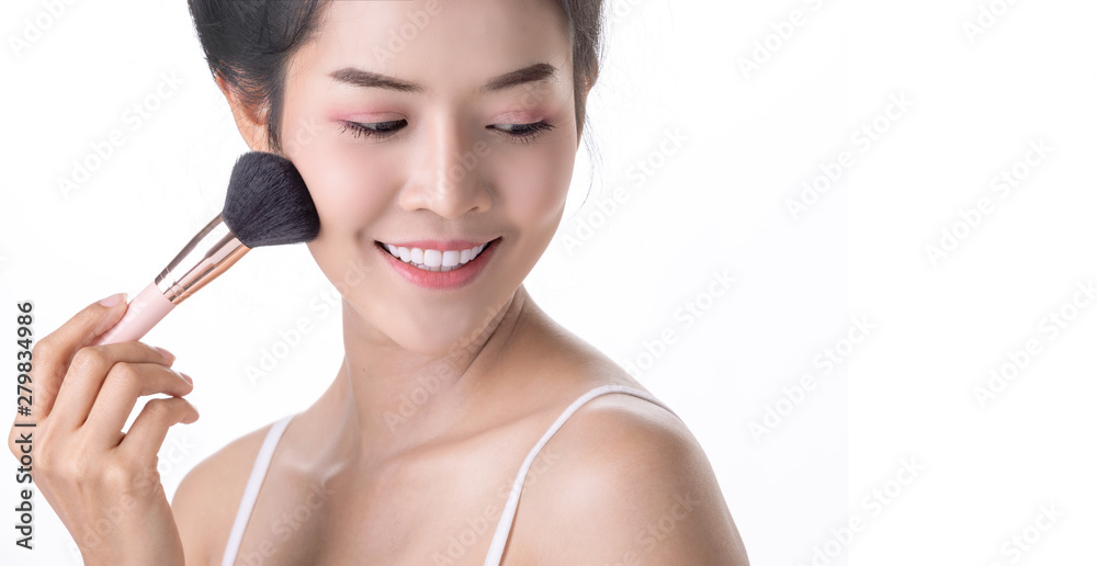 Beautiful Young Asian Woman using Soft Brush and Cosmetic on own face. Cosmetologist, Skin care or Beauty concept Beautiful Young Asian Woman using Soft Brush and Cosmetic on own face. Cosmetologist, Skin care or Beauty concept