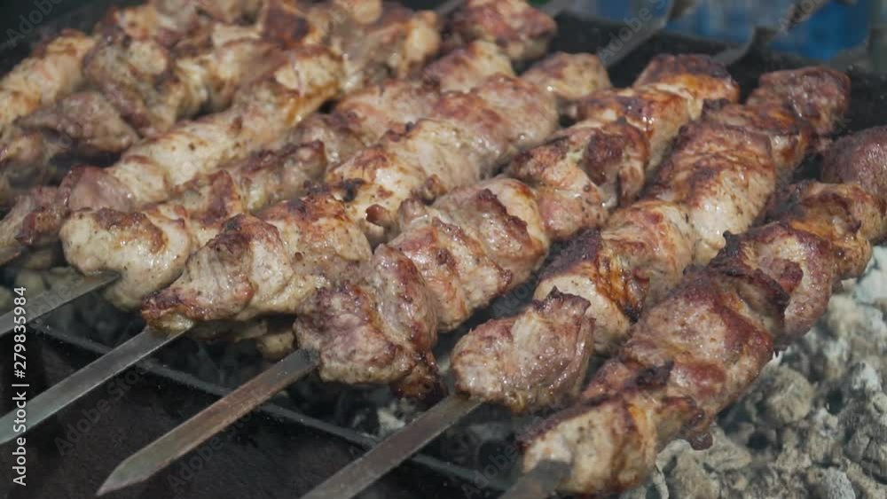juicy delicious kebabs with a ruddy crust on the grill, smoked on the coals juicy delicious kebabs with a ruddy crust on the grill, smoked on the coals