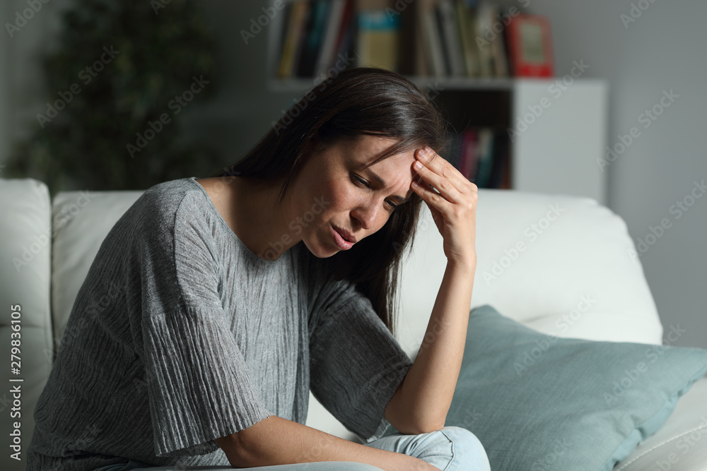 Woman at home suffering head ache in the night