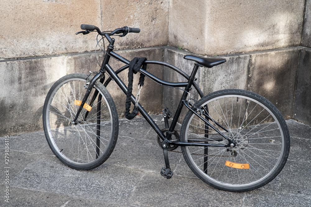 Locked bicycle parked on the street