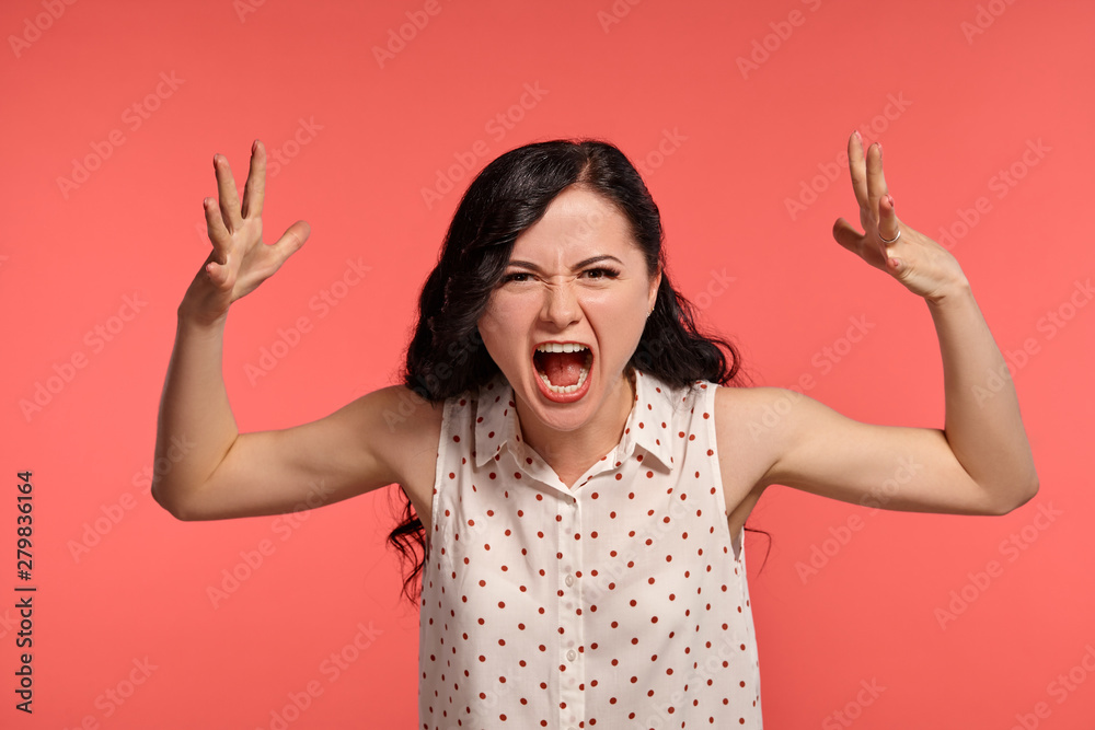 Studio shot of a lovely girl teenager posing over a pink background. Studio shot of a lovely girl teenager posing over a pink background.
