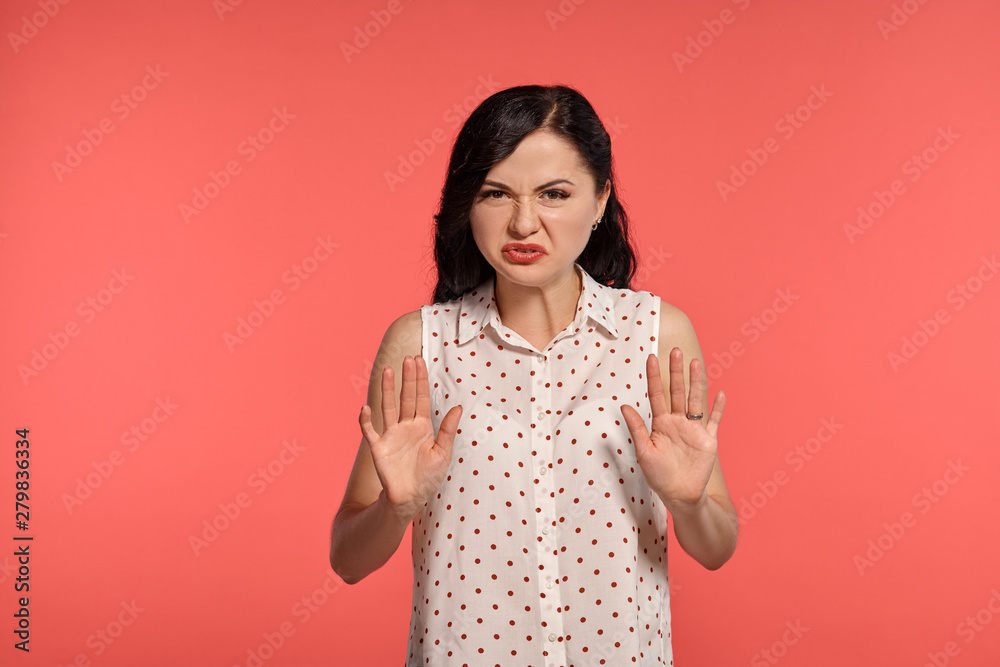 Studio shot of a lovely girl teenager posing over a pink background. Studio shot of a lovely girl teenager posing over a pink background.
