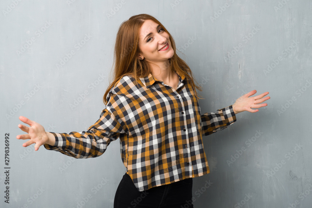 Young redhead girl over grunge wall proud and self-satisfied in love yourself concept Young redhead girl over grunge wall proud and self-satisfied in love yourself concept