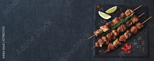 Delicious kebabs with spices. Kebab on wooden sticks. photo