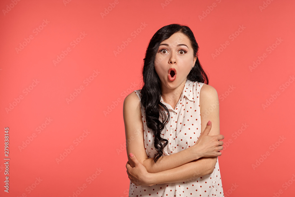 Studio shot of a lovely girl teenager posing over a pink background. Studio shot of a lovely girl teenager posing over a pink background.