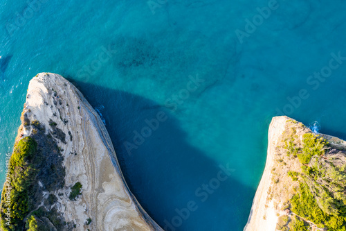 Aerial view of beautiful green rocks in the ocean. Blue sea seen from above.