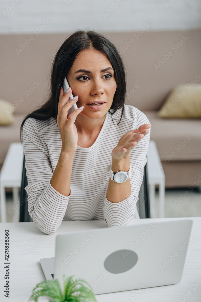 beautiful and brunette woman talking on smartphone in apartment beautiful and brunette woman talking on smartphone in apartment