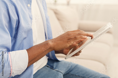 Close up hands of man using digital tablet
