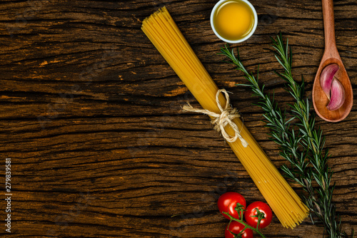 Pasta spaghetti with eggs on old wooden background.