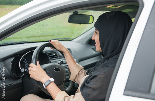 Beautiful arab muslim woman driving car