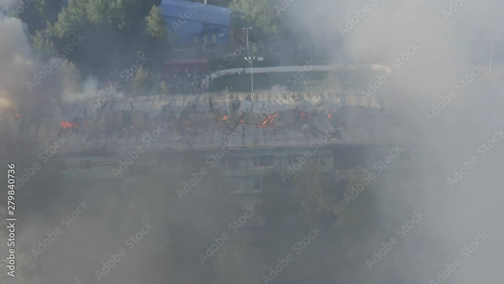 Burning roof of a residential high-rise building, clouds of smoke from the fire. top view Burning roof of a residential high-rise building, clouds of smoke from the fire. top view