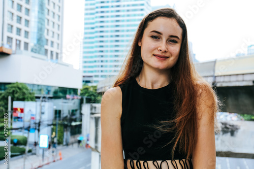Free Download Close-up Beautiful woman happy portrait and office building background. - GFXLoad