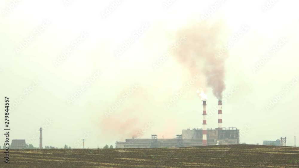 Factory pipes polluting an air. Dirty smoke coming out from chimney. Concept of ecology problem. Factory pipes polluting an air. Dirty smoke coming out from chimney. Concept of ecology problem.