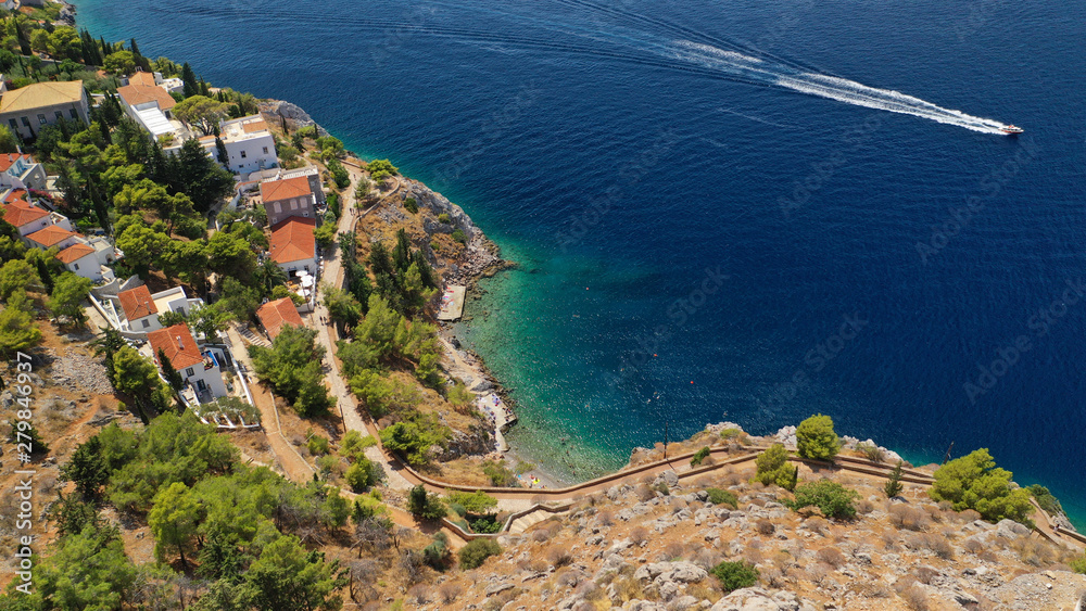 Aerial drone photo of small rocky beach of Avlaki with clear turquoise sea near picturesque main village in island of Ydra or Hydra, Saronic gulf, Greece