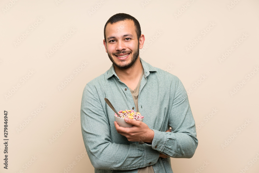 Colombian man with bowl of cereals keeping arms crossed Colombian man with bowl of cereals keeping arms crossed