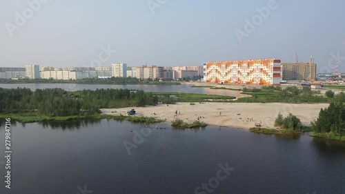 Nadym, RUSSIA - JULY 22, 2019: Citizens resting on the shore of taiga lake on the outskirts of the city photo