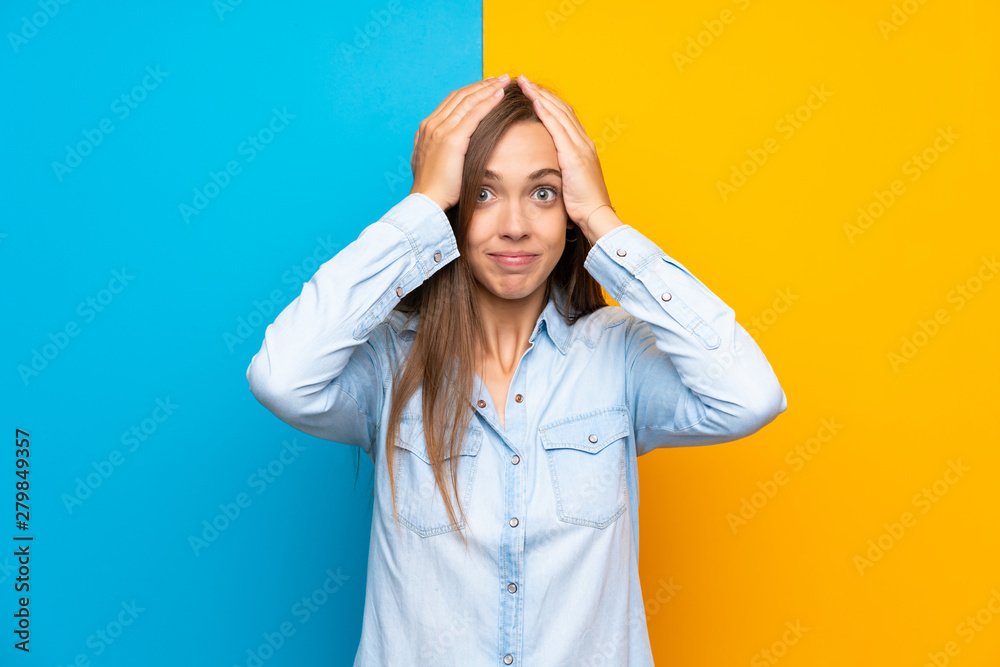 Young woman over colorful background with surprise facial expression Young woman over colorful background with surprise facial expression
