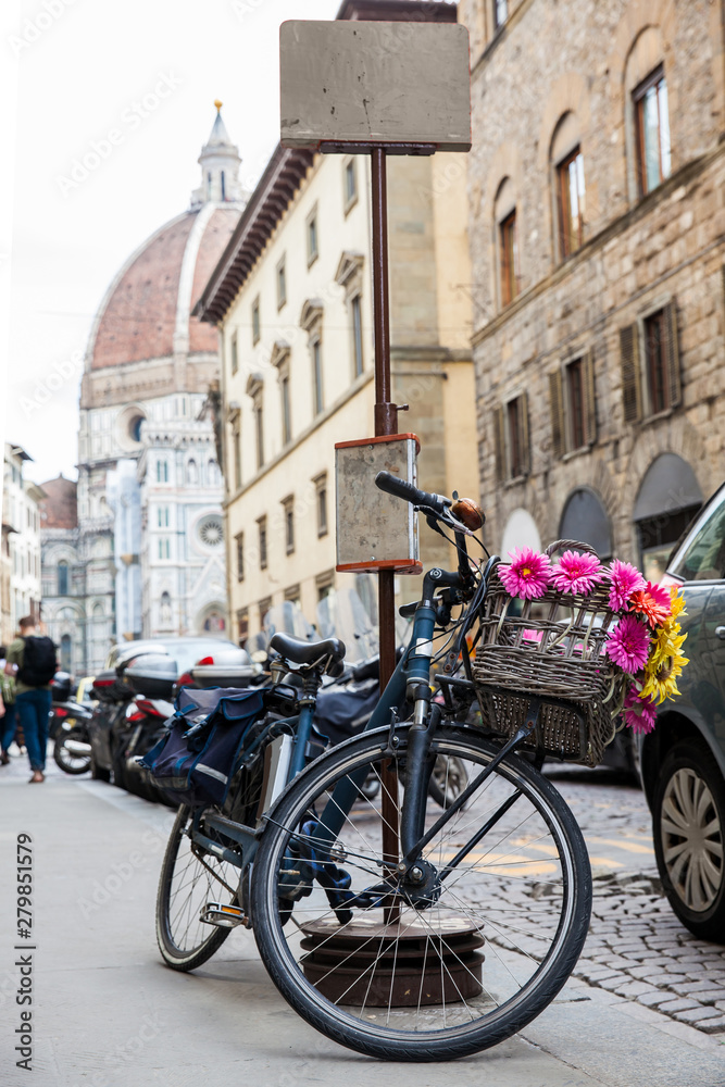 Bicycle decorated with flowers parked at Via de Cerretani in Florence