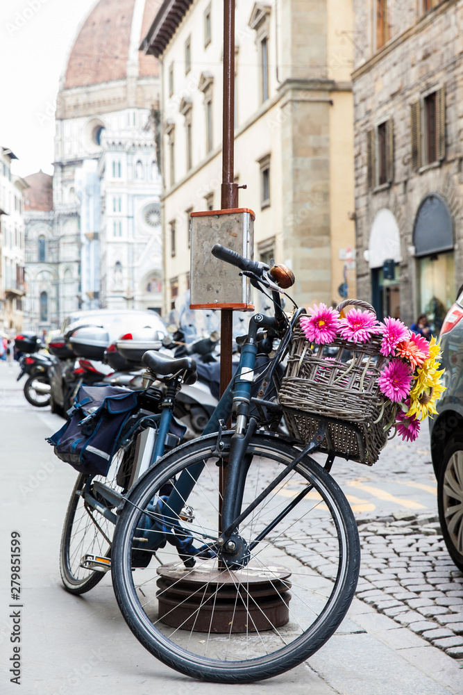 Bicycle decorated with flowers parked at Via de Cerretani in Florence