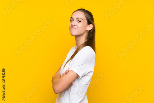 Young woman over isolated yellow background laughing
