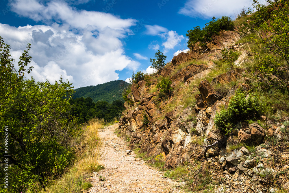 Mountain footpath through forest along the rocks. This is the path to the ruins of the medieval castle Maglic in Serbia.