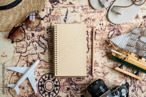Flat lay traveler accessories on map background with copy space for text. Top view travel or vacation concept.