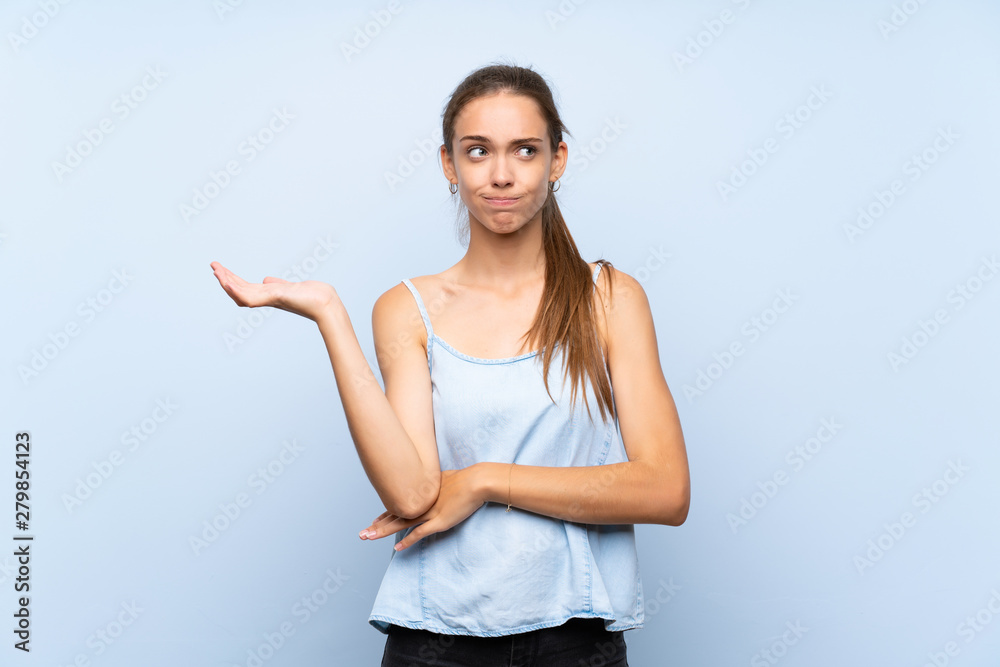 Young woman over isolated blue background unhappy for not understand something Young woman over isolated blue background unhappy for not understand something
