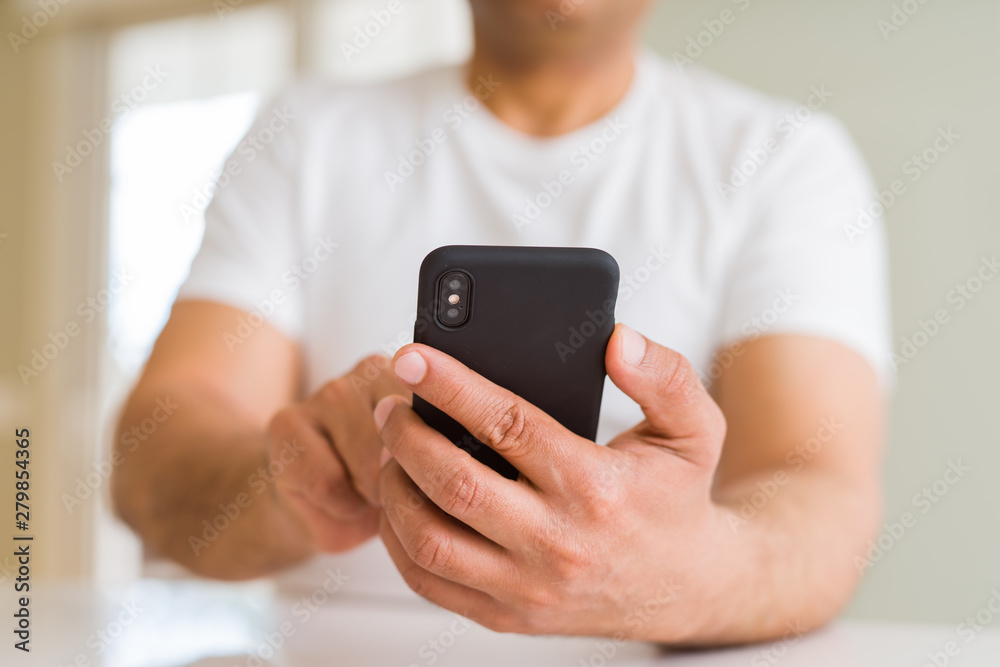 Close up of middle age man hands using smartphone at home Close up of middle age man hands using smartphone at home