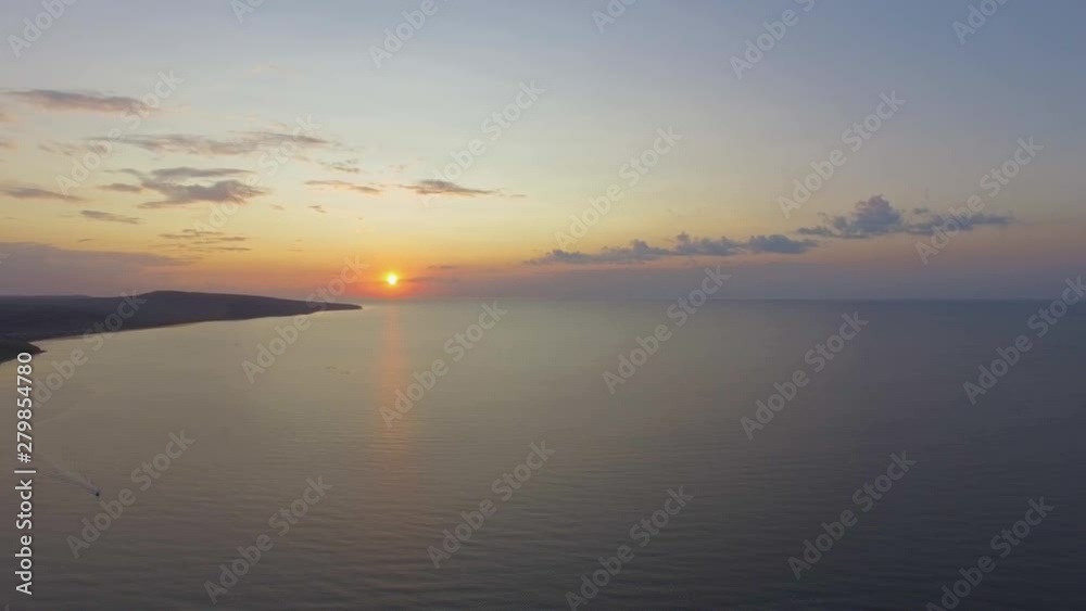Golden sunrise over ocean bay. Golden reflections on sea water surface from sunrise Golden sunrise over ocean bay. Golden reflections on sea water surface from sunrise