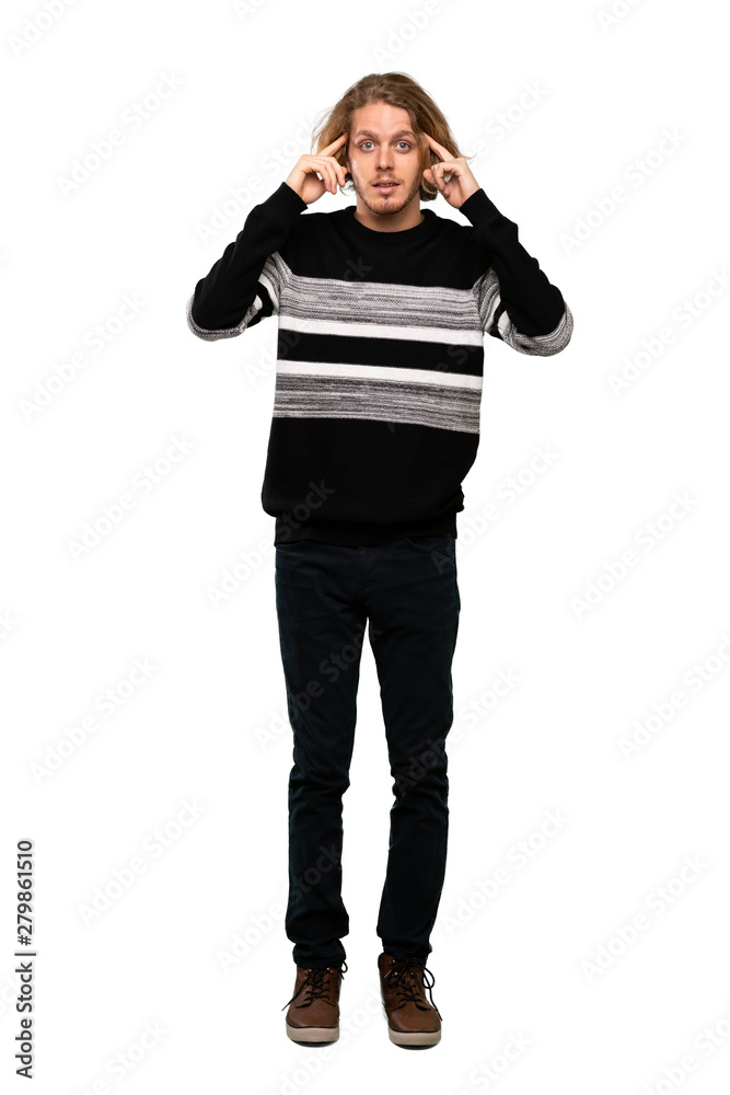 Full-length shot of Blonde man having doubts and thinking over isolated white background Full-length shot of Blonde man having doubts and thinking over isolated white background
