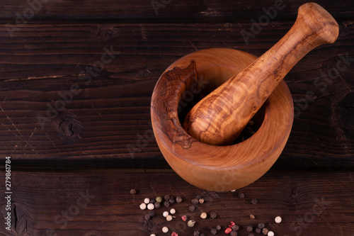 wooden mortar with pepper, low key, olive wood, rustic