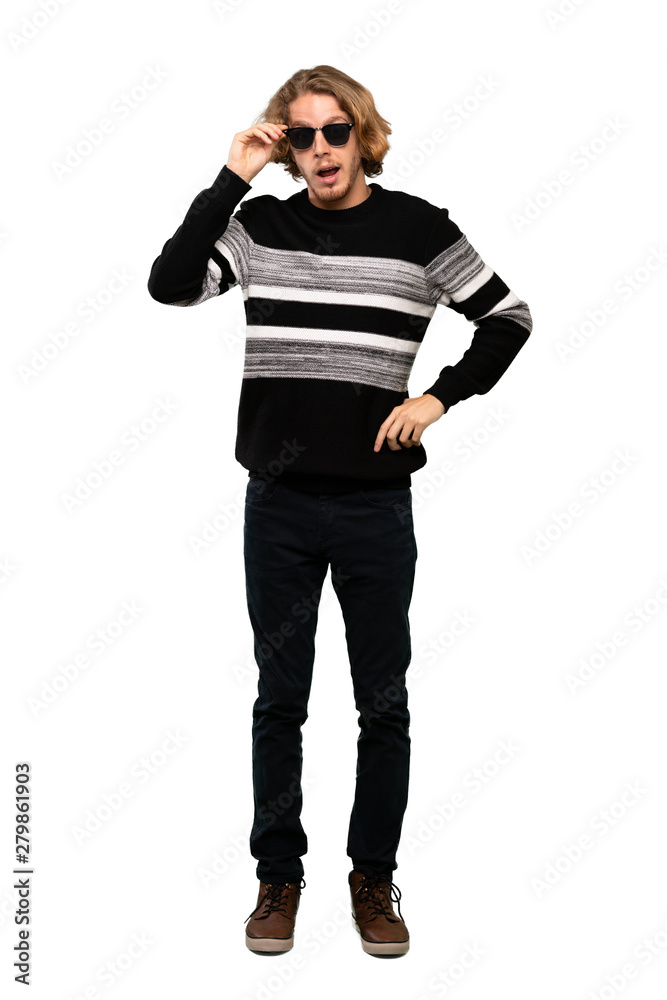 Full-length shot of Blonde man with glasses and surprised over isolated white background Full-length shot of Blonde man with glasses and surprised over isolated white background