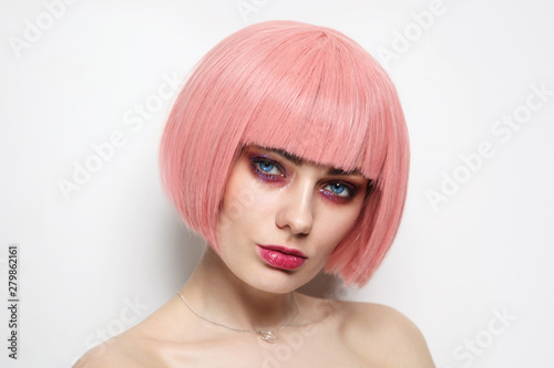Vintage style portrait of young beautiful woman with pink hair and fancy glitter makeup