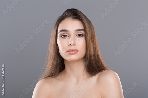 Portrait of confident gorgeous woman grey background