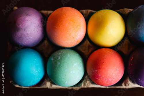 High angle close up of brightly colored Easter eggs.