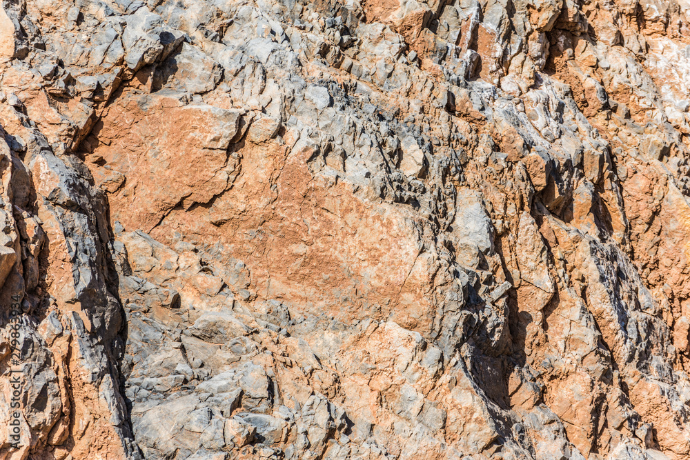 background and texture of mountain layers and cracks in sedimentary rock on cliff face. Cliff of rock mountain.